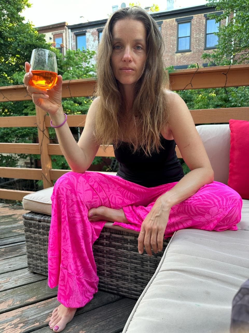 Stephanie on the rooftop with a glass of wine