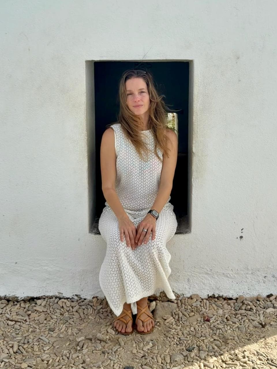 Stephanie sitting in a wall alcove
