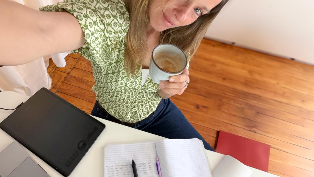 Stephanie with coffee and journal at desk